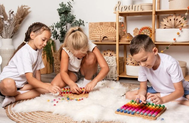 Montessori hundred board with numbers 1-100 and felt balls