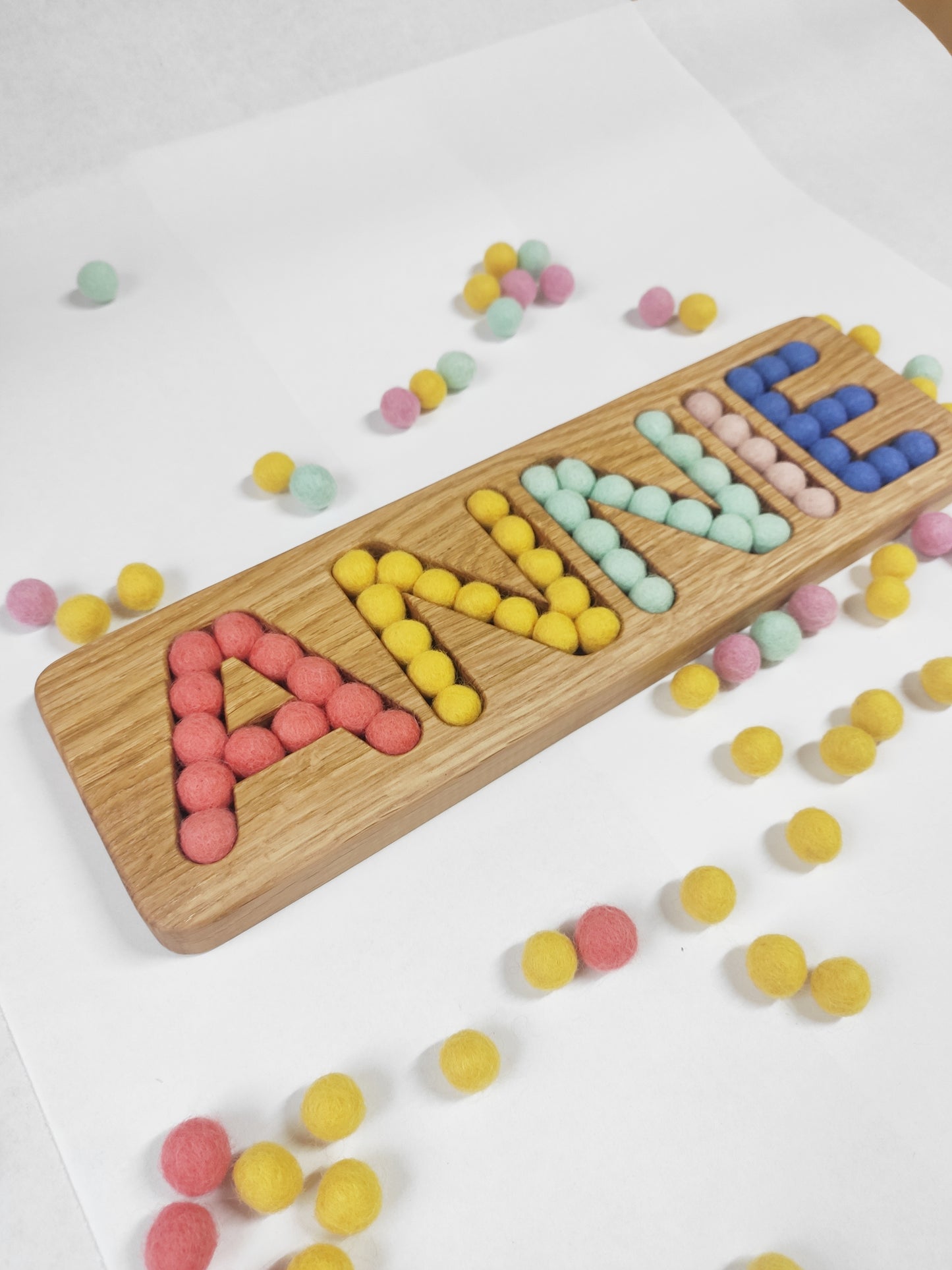 Wooden name board with felt balls