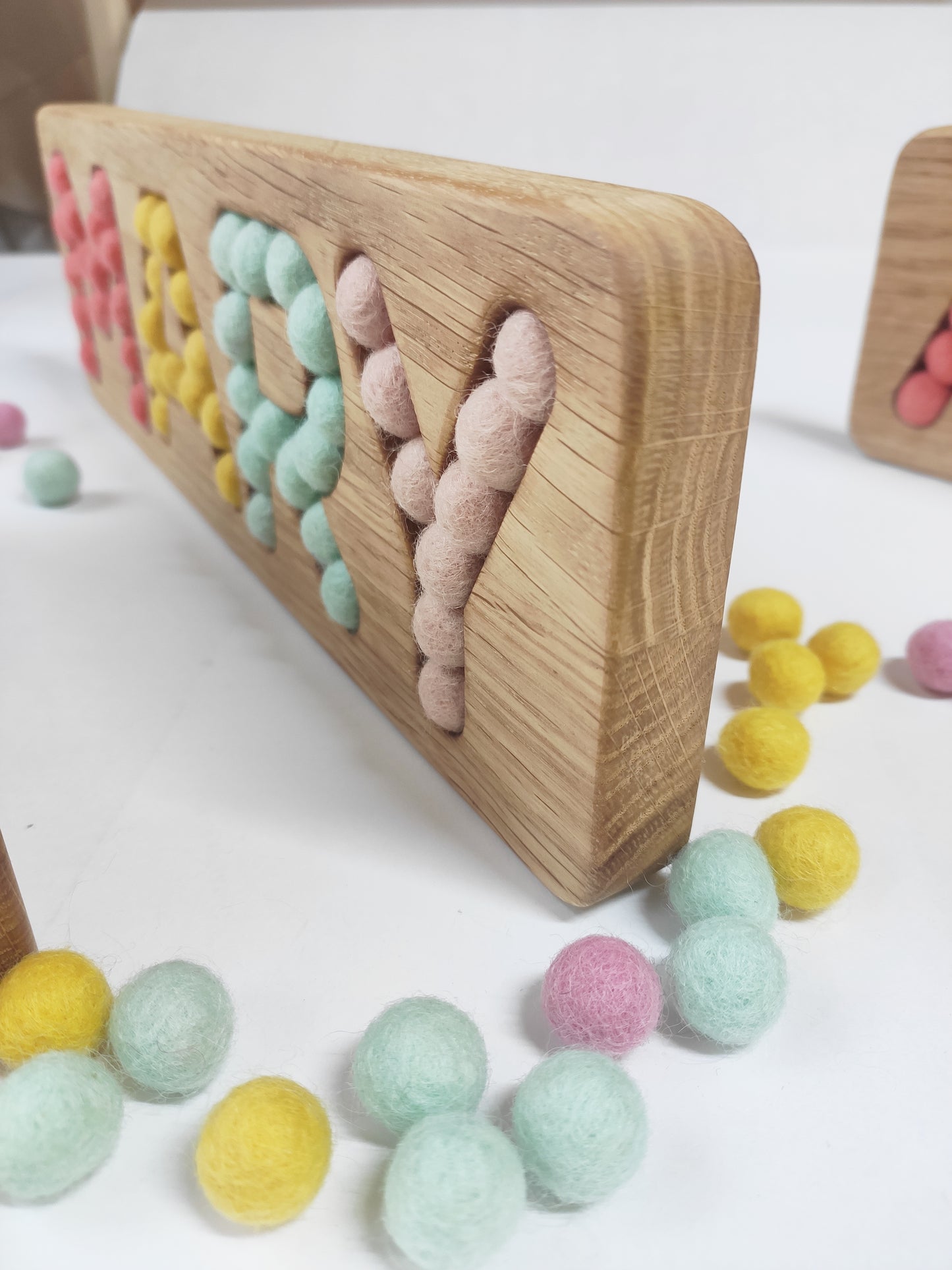 Wooden name board with felt balls