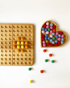 Montessori hundred board with numbers 1-100 and felt balls