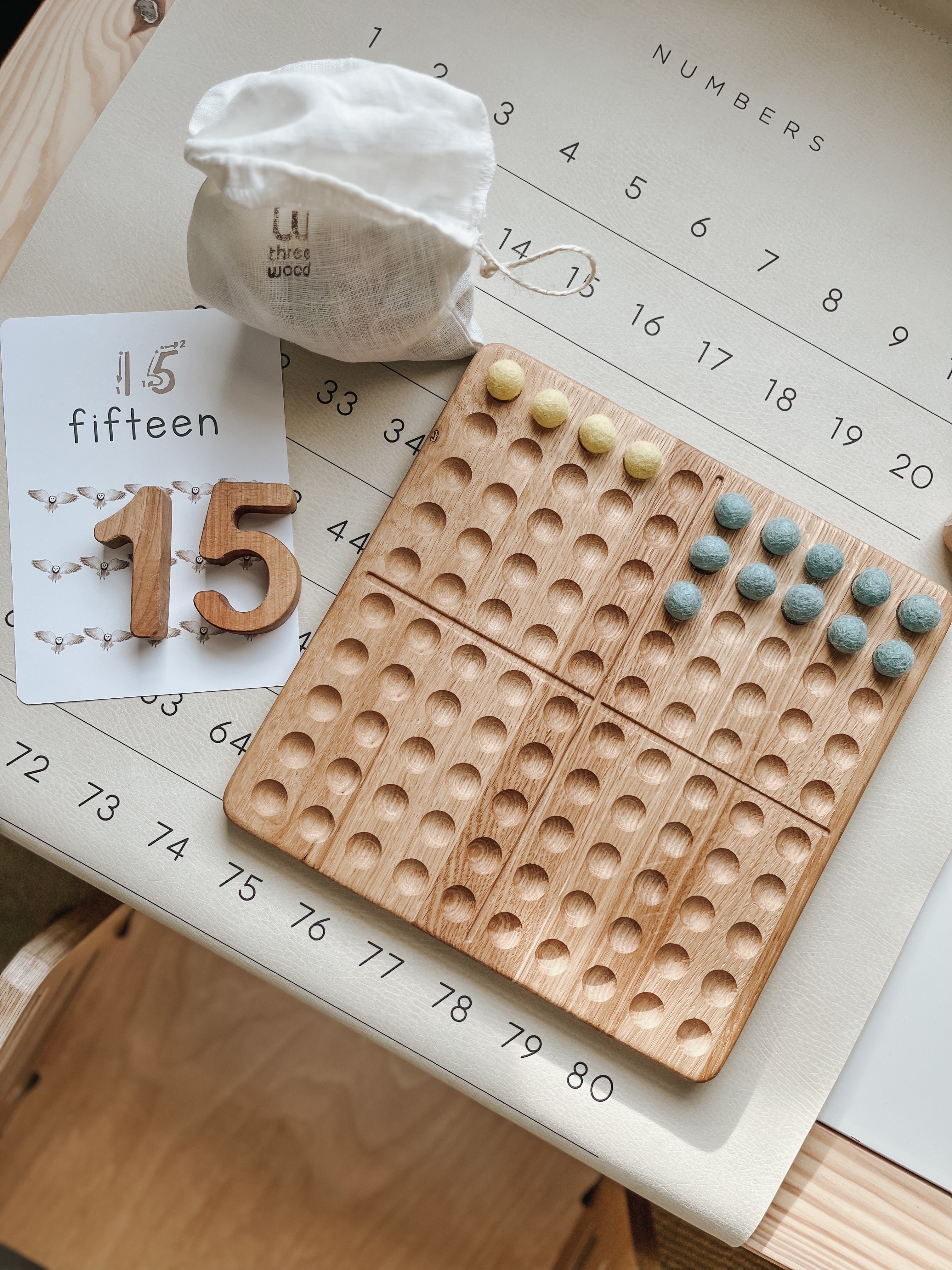 Montessori hundred board with numbers 1-100 and felt balls