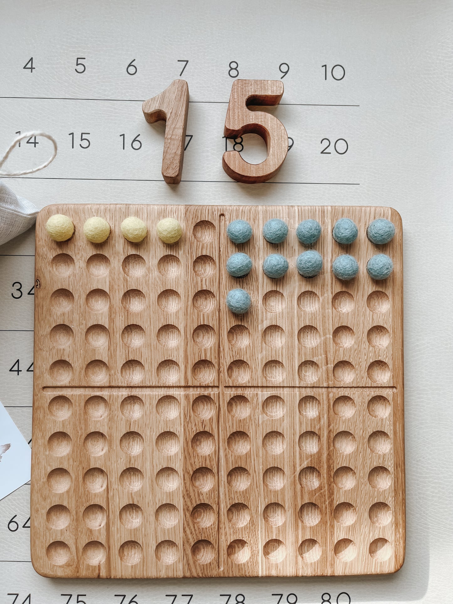 Montessori hundred board with numbers 1-100 and felt balls