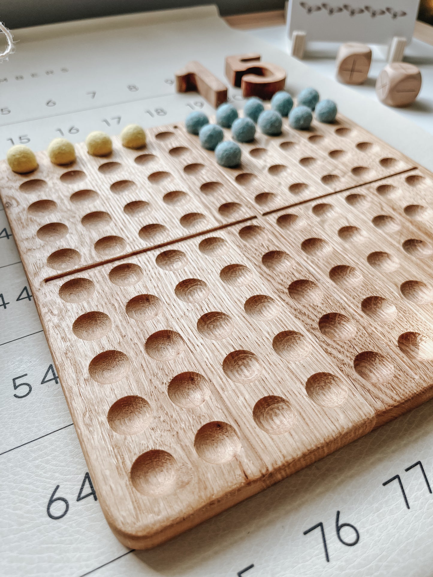 Montessori hundred board with numbers 1-100 and felt balls