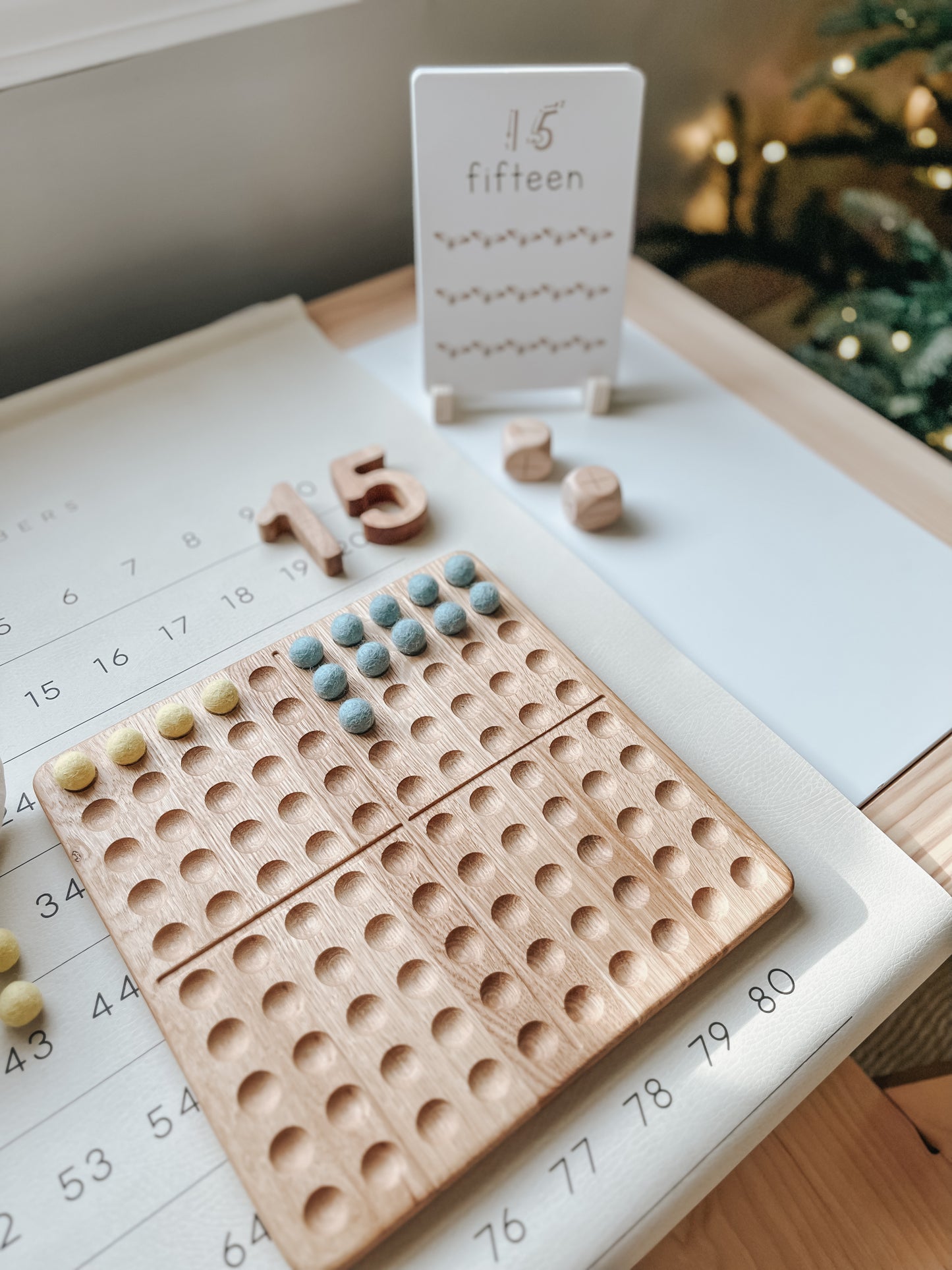 Montessori hundred board with numbers 1-100 and felt balls