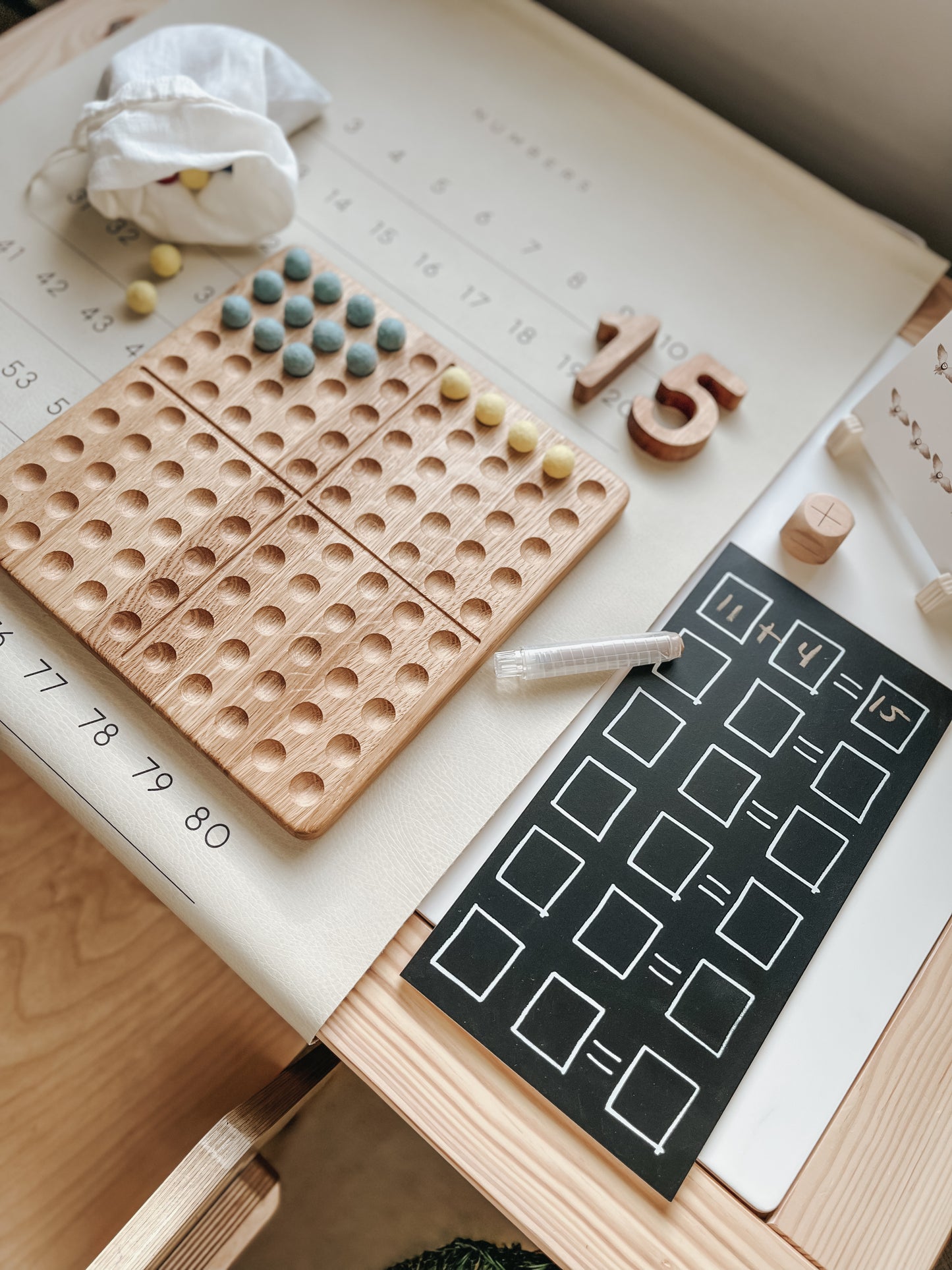 Montessori hundred board with numbers 1-100 and felt balls