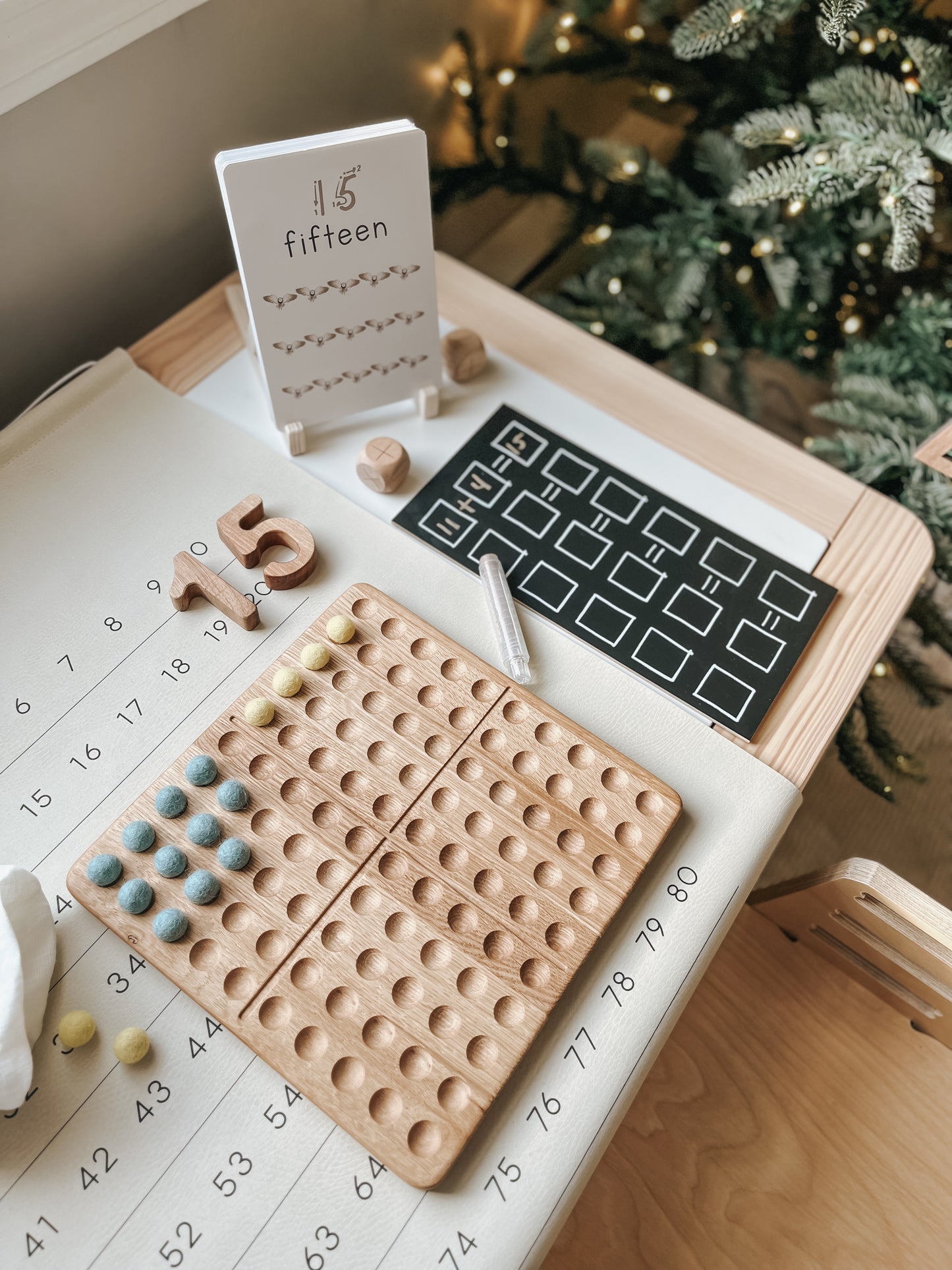 Montessori hundred board with numbers 1-100 and felt balls