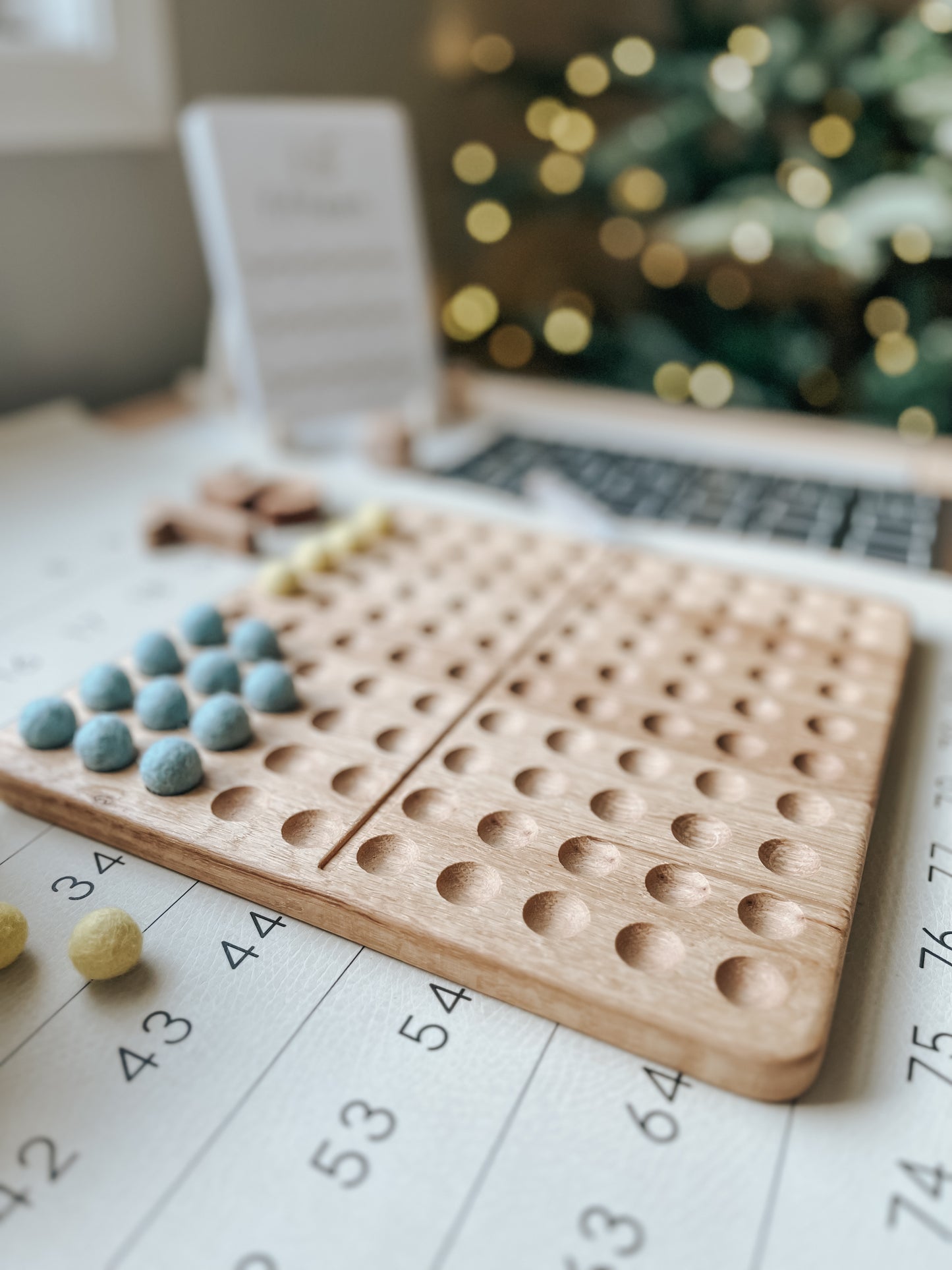 Montessori hundred board with numbers 1-100 and felt balls