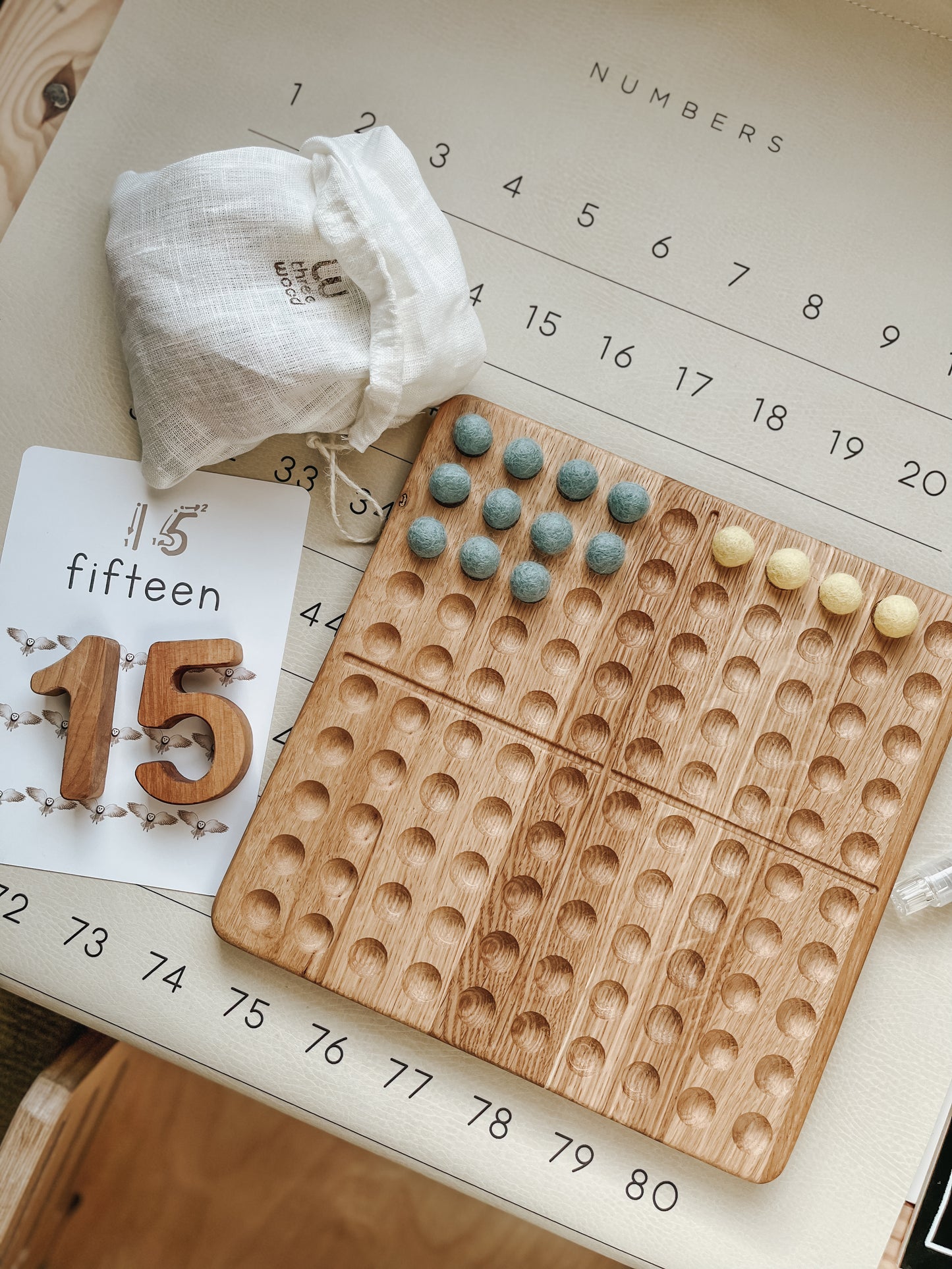 Montessori hundred board with numbers 1-100 and felt balls