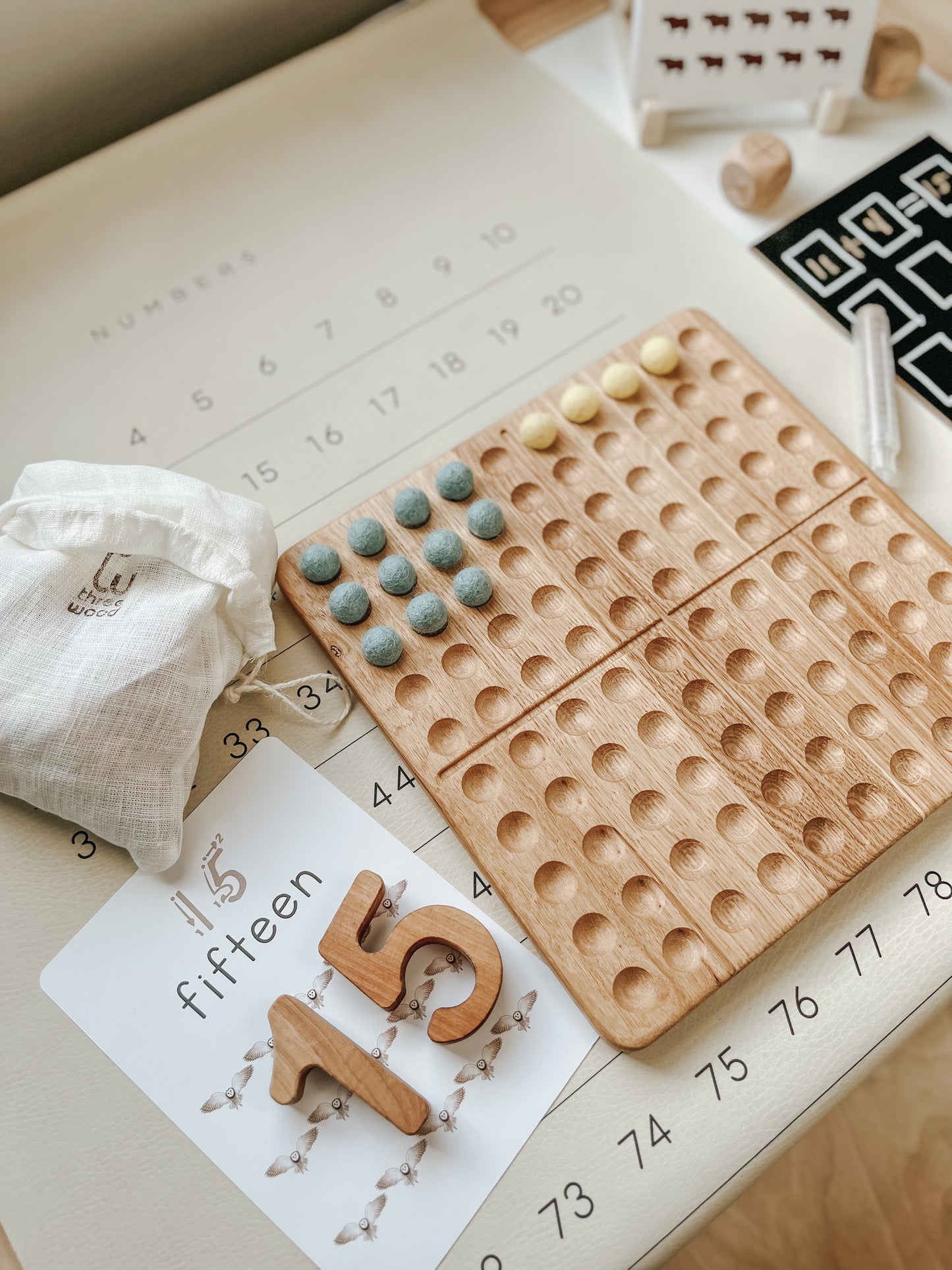 Montessori hundred board with numbers 1-100 and felt balls