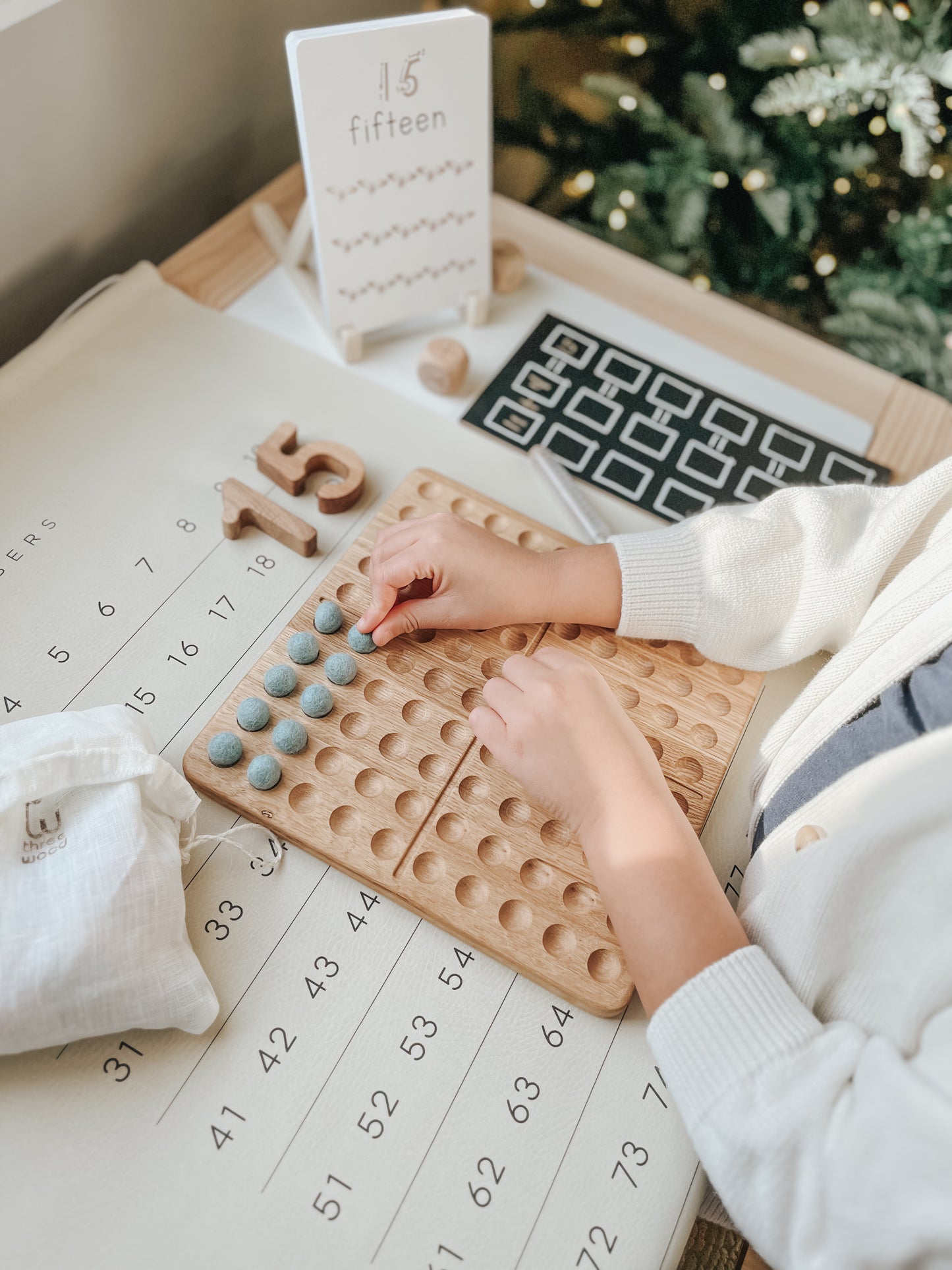 Montessori hundred board with numbers 1-100 and felt balls