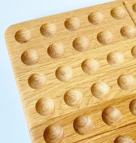 Montessori hundred board with numbers 1-100 and felt balls