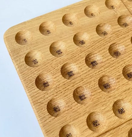 Montessori hundred board with numbers 1-100 and felt balls