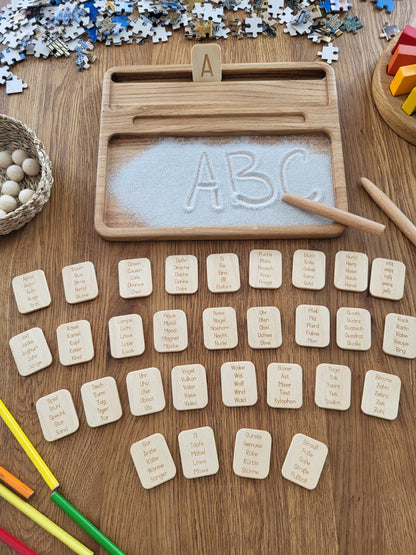 Sand tray with German letters cards