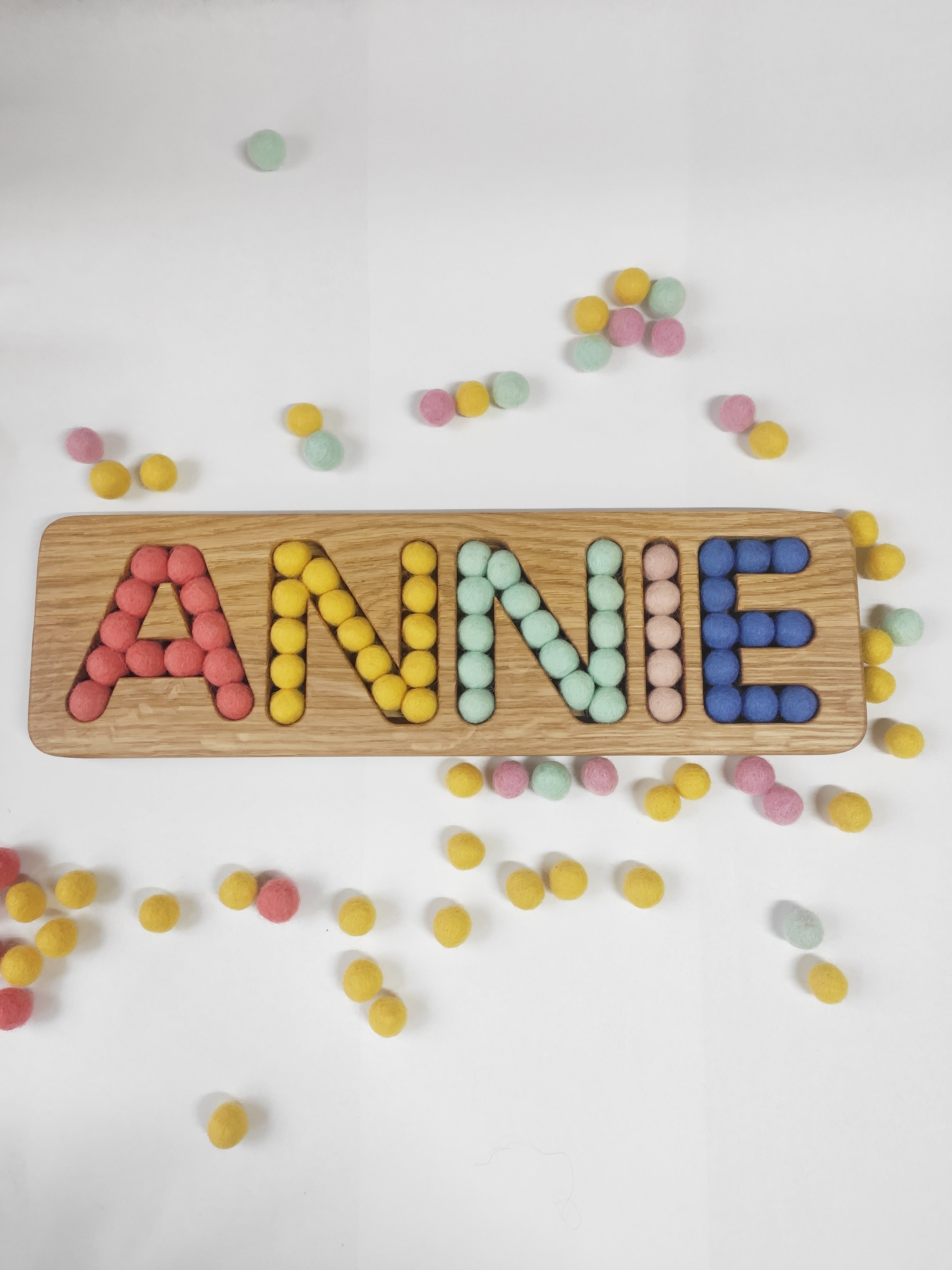 Wooden name board with felt balls